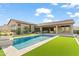 Luxury backyard with a large pool and grassy area at 13222 E Ranch Gate Rd, Scottsdale, AZ 85255