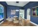 Elegant dining room with hardwood floors, glass table, and modern lighting at 1325 W Lynwood St, Phoenix, AZ 85007