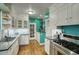 Eat-in kitchen with white cabinets, teal walls, and stainless steel appliances at 1325 W Lynwood St, Phoenix, AZ 85007