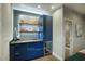 Modern wet bar with blue cabinetry and mini fridge at 1325 W Lynwood St, Phoenix, AZ 85007