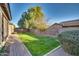 Private backyard with grassy area and walkway at 13813 W Monterey Way, Avondale, AZ 85392