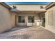 Covered patio with brick pavers and access to grassy backyard at 13813 W Monterey Way, Avondale, AZ 85392