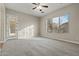 Spacious bedroom featuring neutral carpeting and a large window at 13813 W Monterey Way, Avondale, AZ 85392