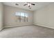 Bright bedroom with ceiling fan and neutral carpeting at 13813 W Monterey Way, Avondale, AZ 85392