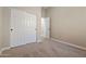 Bedroom with carpeted floor and double door closet at 13813 W Monterey Way, Avondale, AZ 85392