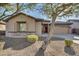 One-story house with a two-car garage, stone accents, and desert landscaping at 13813 W Monterey Way, Avondale, AZ 85392