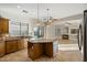 Island kitchen with granite countertops and wood cabinets at 13813 W Monterey Way, Avondale, AZ 85392