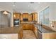 Modern kitchen with granite counters and wood cabinetry at 13813 W Monterey Way, Avondale, AZ 85392