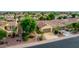 Single-story home with a two-car garage and lush landscaping at 13827 W Junipero Dr, Sun City West, AZ 85375