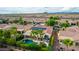 Aerial view of a community with houses, pools, and solar panels at 13827 W Junipero Dr, Sun City West, AZ 85375