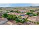 Aerial view of houses with solar panels and a community pool at 13827 W Junipero Dr, Sun City West, AZ 85375