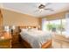 Bright bedroom with large window and wood furniture at 13827 W Junipero Dr, Sun City West, AZ 85375