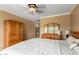 Spacious bedroom with large bed and wood armoire at 13827 W Junipero Dr, Sun City West, AZ 85375