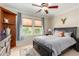 Bedroom with king-size bed, wood dresser and window at 13827 W Junipero Dr, Sun City West, AZ 85375