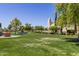 Landscaped lawn with fountain and community building at 13827 W Junipero Dr, Sun City West, AZ 85375