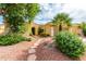 House exterior with a stone walkway and lush landscaping at 13827 W Junipero Dr, Sun City West, AZ 85375