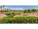 Landscaped golf course with pond and palm trees at 13827 W Junipero Dr, Sun City West, AZ 85375