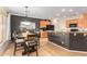 Eat-in kitchen with granite countertops and dark wood cabinets at 13827 W Junipero Dr, Sun City West, AZ 85375