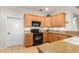 Well-equipped kitchen with light wood cabinets and granite counters at 13827 W Junipero Dr, Sun City West, AZ 85375