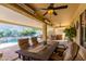 Covered patio with outdoor dining set and pool view at 13827 W Junipero Dr, Sun City West, AZ 85375