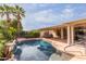 Inviting pool with waterfall feature and spacious patio at 13827 W Junipero Dr, Sun City West, AZ 85375