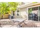 Private backyard patio with brick pavers, table, and mature trees at 1421 N 80Th Ln, Phoenix, AZ 85043