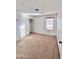 Well-lit bedroom featuring carpet, a closet, and window at 1421 N 80Th Ln, Phoenix, AZ 85043