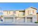 Tan two-story townhome with three-car garage and balcony at 1421 N 80Th Ln, Phoenix, AZ 85043