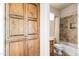 Guest bathroom with a shower/tub combination and wood cabinetry at 14216 S Canyon Dr, Phoenix, AZ 85048