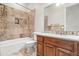 Bathroom with granite vanity and tiled shower/tub at 14216 S Canyon Dr, Phoenix, AZ 85048