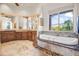 Luxurious bathroom with soaking tub and mountain views at 14216 S Canyon Dr, Phoenix, AZ 85048