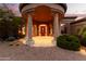 Stunning entryway with a large wooden door, columns, and warm lighting at 14216 S Canyon Dr, Phoenix, AZ 85048