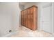 Laundry room with tall wooden storage cabinet at 14216 S Canyon Dr, Phoenix, AZ 85048