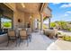 Covered patio with outdoor kitchen, dining furniture, and ceiling fans at 14216 S Canyon Dr, Phoenix, AZ 85048