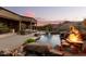 Luxury pool and patio area with mountain backdrop at 14216 S Canyon Dr, Phoenix, AZ 85048