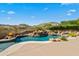 Luxury pool with a waterfall and fire pit features at 14216 S Canyon Dr, Phoenix, AZ 85048