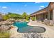 Luxury pool with a waterfall and fire pit features at 14216 S Canyon Dr, Phoenix, AZ 85048