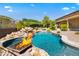 Luxury pool with a waterfall and fire pit features at 14216 S Canyon Dr, Phoenix, AZ 85048