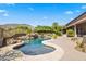 Luxury pool with a waterfall and fire pit features at 14216 S Canyon Dr, Phoenix, AZ 85048