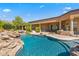 Inviting pool with a waterfall feature and expansive patio at 14216 S Canyon Dr, Phoenix, AZ 85048