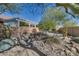 Landscaped backyard with a dry creek bed, rocks, and desert plants at 14731 W Trading Post Dr, Sun City West, AZ 85375