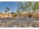 Backyard with gravel landscaping, rock formations, and mature trees at 14731 W Trading Post Dr, Sun City West, AZ 85375