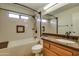 Updated bathroom with tub, shower, and wood vanity at 14731 W Trading Post Dr, Sun City West, AZ 85375