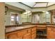 Bathroom with double vanity, granite countertop, and large mirror at 14731 W Trading Post Dr, Sun City West, AZ 85375