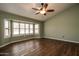 Bedroom with wood flooring, bay window and ceiling fan at 14731 W Trading Post Dr, Sun City West, AZ 85375