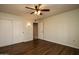 Bedroom with hardwood floors, ceiling fan, and sliding door closet at 14731 W Trading Post Dr, Sun City West, AZ 85375