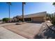 House with a tan exterior, tile roof, and palm trees at 14731 W Trading Post Dr, Sun City West, AZ 85375