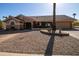 Tan house with tile roof, landscaping, and a two-car garage at 14731 W Trading Post Dr, Sun City West, AZ 85375