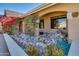 Landscaped entryway with a rock garden and flowering plants at 14731 W Trading Post Dr, Sun City West, AZ 85375