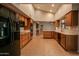 Bright kitchen featuring wood cabinets, black appliances, and tile floors at 14731 W Trading Post Dr, Sun City West, AZ 85375